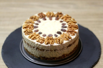 Vegan cake with walnuts, cashew nuts and raisins. Selective focus.