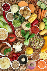 Healthy vegan super food collection with fruit, vegetables, nuts, spice, dips, grains, tofu, falafel & tofu burgers  High in vitamins, minerals, antioxidants, dietary fibre & smart carbs. Flat lay.
