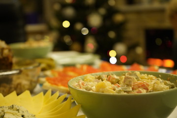 Dishes with food on the New Year's holiday table. New Year's holiday table. Salads, meat, alcohol on the New Year's table.