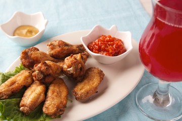  fresh fried chicken legs with sauce and herbs