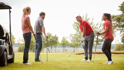 Golf Professional Demonstrating Shot On Fairway To Group Of Golfers During Lesson - Powered by Adobe