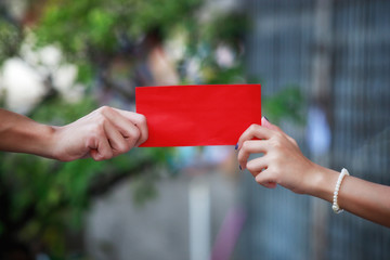 The elders hand give red envelope 
