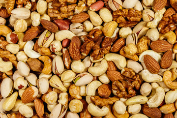 Background of mixed nuts (walnuts, pistachio, almond, peanut, cashew, hazelnut). Healthy eating concept