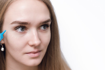 Naklejka premium Close up of the face of a beautiful woman with perfect skin thanks to creams to keep young and cream contour anti-aging and wrinkle eyes. Eye Skin Care
