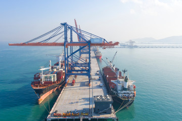 Naklejka premium Container ship in export and import business and logistics. Shipping cargo to harbor by crane. Water transport International. Aerial view and top view.