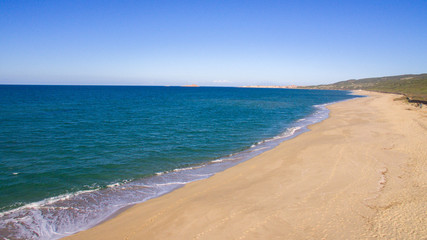 beautiful aerial panorama with the drone of the famous beaches at the Sardinian sea with the isola rossa and castelsardo behind