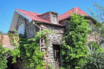  Russia, the city of Rostov-on-Don, May 2019.Fabulous house of stones on a background of blue sky. Summer house home-made in a summer cottage.                 