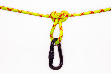 New Black oval touristic and alpinistic carabine hangs from Butterfly loop knot. Stretched colored, green rope for personal belaying. Self-insurance mustache. Isolated on white background.