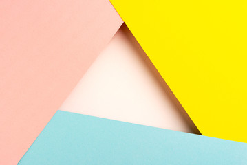 Paper background of yellow ,blue, pink sheets, white triangular hole in the center with an empty space for text