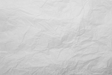 White crumpled creased paper sheet texture background. Old and dilapidated paper with kinks and...