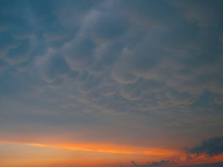 Picturesque view of a puffy blanket of clouds covering the sunny morning sky.