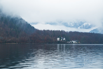Winter lake surrounded by snow mountains of hallstatt in Austria.