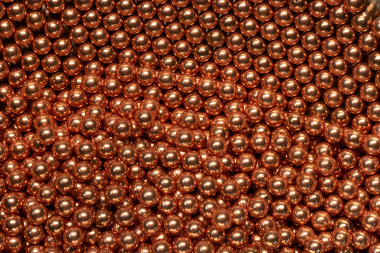 Macro Copper and steel ball bearings in repeating pattern 4