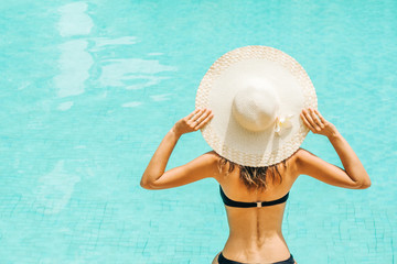 Pretty woman enjoying a swimming pool at the resort
