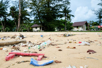 Spilled plastic on the beach. Ecological problem concept