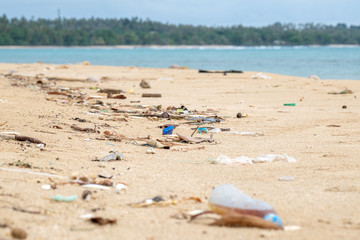 Fototapeta na wymiar Spilled garbage on the beach