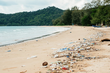 Plastic bottles and other trash on sea beach