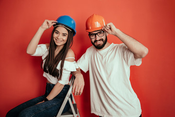 Excited young female and male builders rejoice successful finishing of construction, have great...