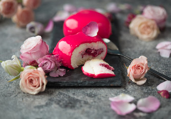 colored mousse cakes in the shape of a heart decorated with mini hearts on festive background. Heart shaped cakes for Valentines Day or Mothers day. Top view. Flat lay