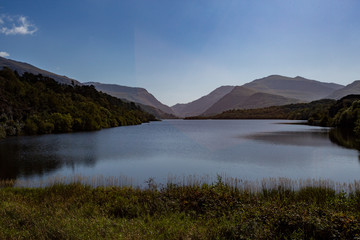 Fototapeta na wymiar View along Llyn Padarn lake looking towards Snowdonia mountain range, North Wales