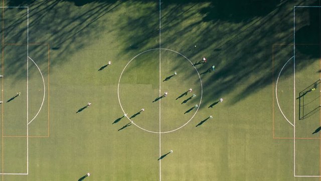 Top view of football field with people playing game