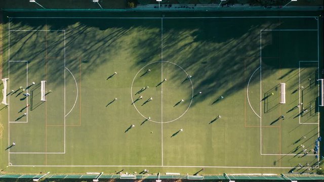 Top view of football field with people playing game
