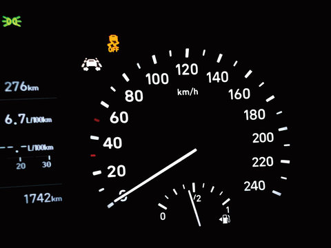 Illustration of modern car dashboard with circular speedometer, fuel gauge indicator, odometer, traction control ASR and parking lights icon. Close up of petrol level showing on car instrument panel.