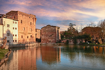 Fototapeta na wymiar Monteroni d'Arbia, Siena, Tuscany, Italy: view at sunset of the ancient water mill and the pond 
