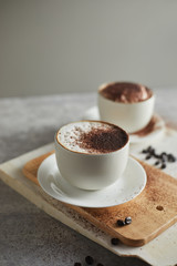 Coffee cup and coffee beans on table..