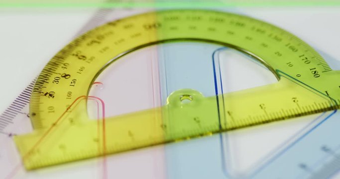 Showcases a set of protractors laid out on a table
