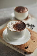 Coffee cup and coffee beans on table..