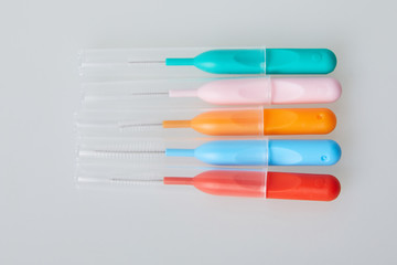 Brushes for braces, toothbrushes for interdental spaces on white background. Close up. Macro. The concept of good mouth hygiene. Different sizes of interdental / interproximal tooth brushes