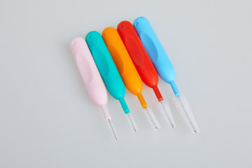 Brushes for braces, toothbrushes for interdental spaces on white background. Close up. Macro. The concept of good mouth hygiene. Different sizes of interdental / interproximal tooth brushes