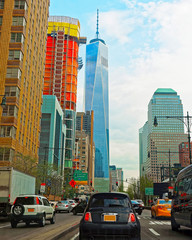Car traffic on road and Skyline with Skyscrapers in Financial Center at Lower Manhattan, New York City, America. USA. American architecture building. Panorama of Metropolis NYC. Metropolitan Cityscape