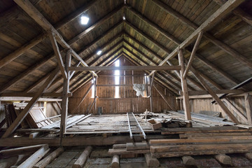 Old and dusty creepy wooden attic with roof framework structure of the old house Awesome horror attic