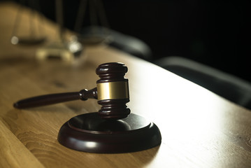 Law and Justice concept. Mallet of the judge, books, scales of justice. Gray stone background,...