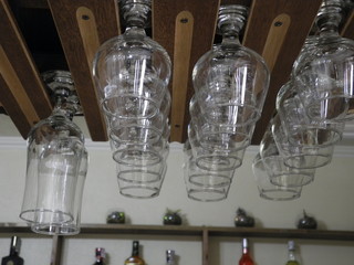 glasses for drinks hanging from a shelf