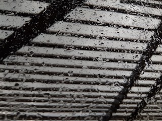 raindrops on the window glass in autumn behind bars