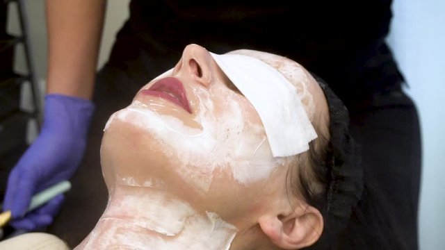 close up view of a young polish European woman receiving a relaxing facial treatment at a local spa from a well trained dermatologist. The client beauty therapy is great for skin care and health