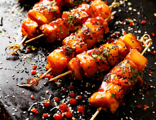 Grilled skewers with pineapple fruit and chicken meat  with sriracha sauce, sprinkled with sesame...