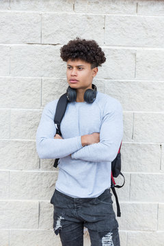 Portrait of young man standing at a wall