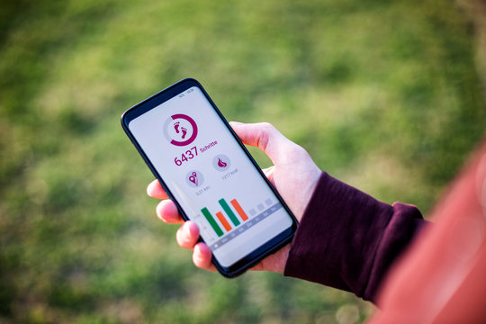 Man holding smartphone, using fitness app