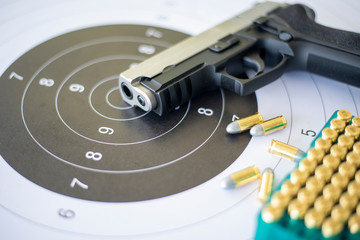 Guns with ammunition on paper target shooting   practice