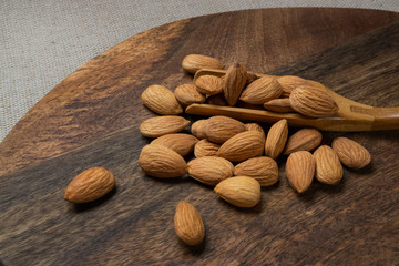 Almonds nuts on a wooden cutting board