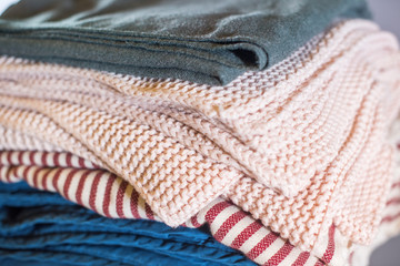 Stack cozy beige blue plaids on grey wall. Home