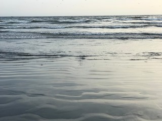 waves on beach at sunset