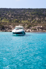 Fototapeta na wymiar Speedboat waving in blue lagoon of Mediterranean sea. Cyprus island