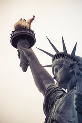 Fototapeta premium Looking up at the Statute of Liberty with a neutral background.