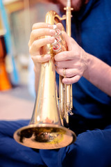 A man plays the trumpet. Shallow depth of field