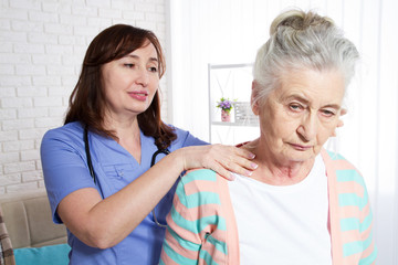 An elderly woman and a rehabilitation doctor - rehabilitation and health concept of older people